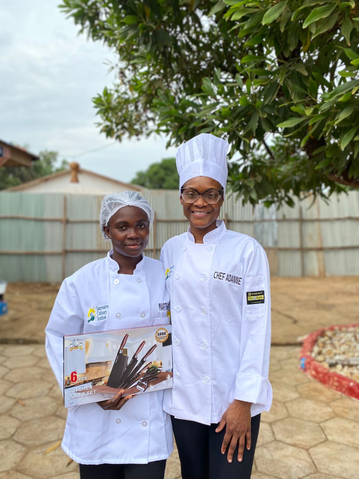 Chef Adanne with a student presenting a 6-piece kitchen knife set