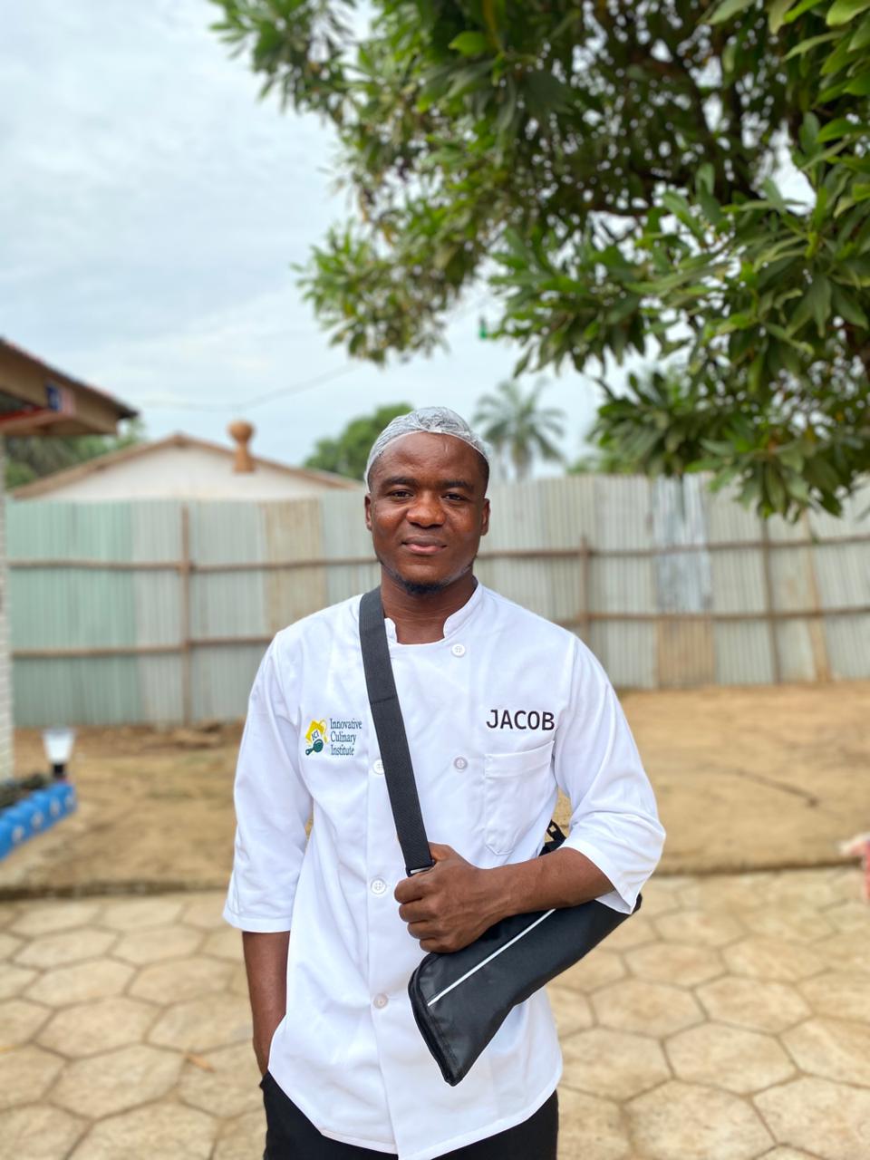 Chef Jacob holding his knife roll outside the institute