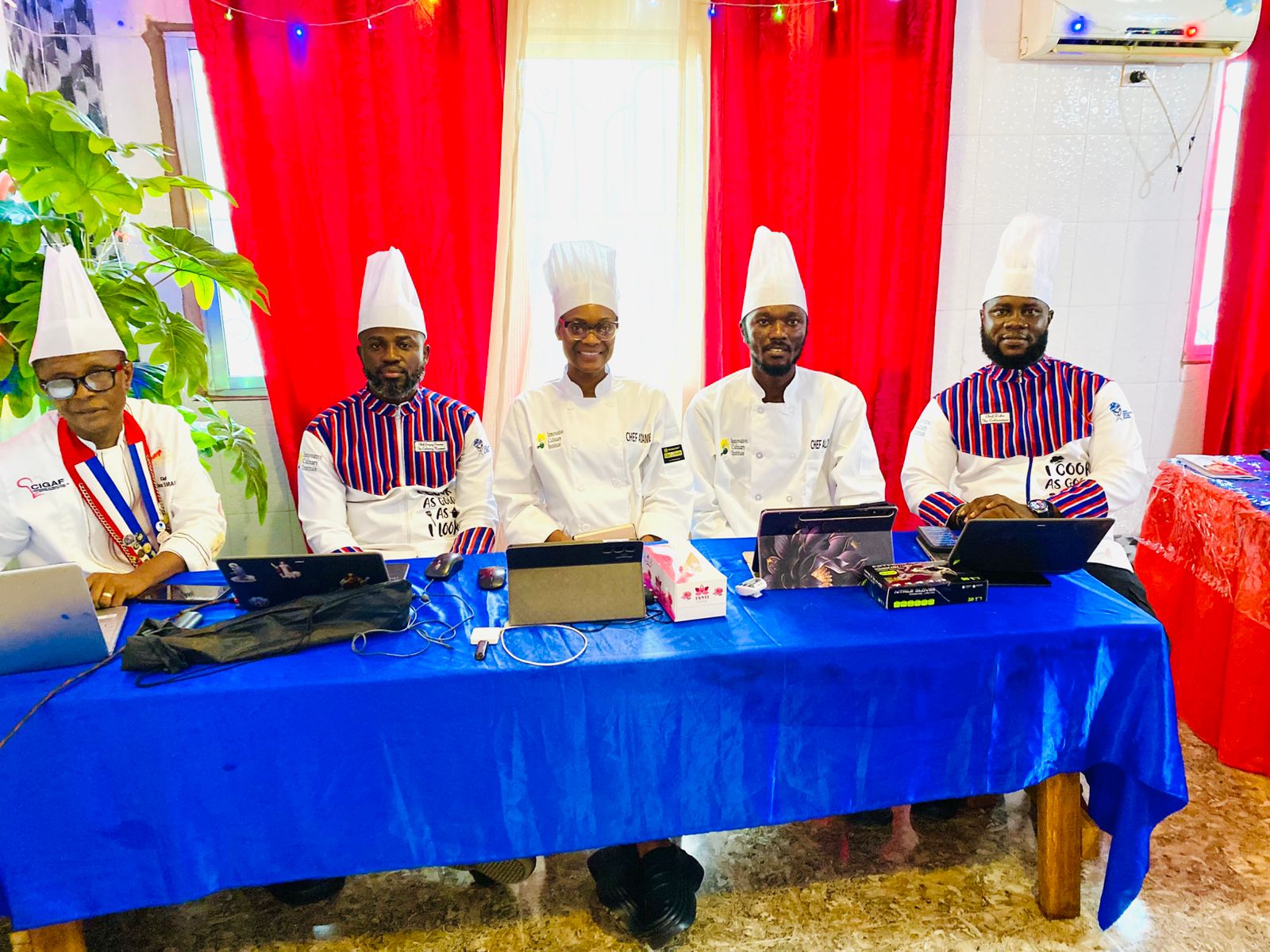 Judging panel of chefs seated at the competition table