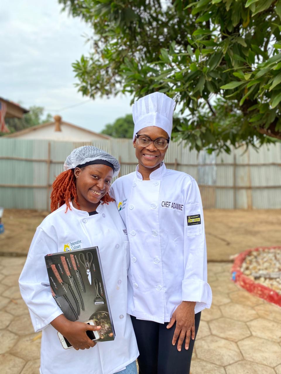 Chef Adanne with a student holding a knife set